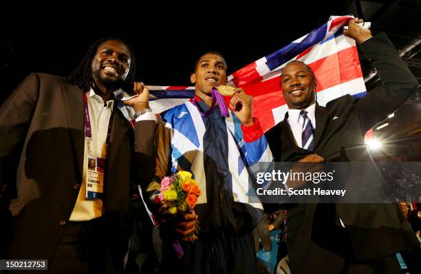 Gold medalist Anthony Joshua of Great Britain celebrates with former world heavweight boxing champion Lennox Lewis and British professional boxer and...