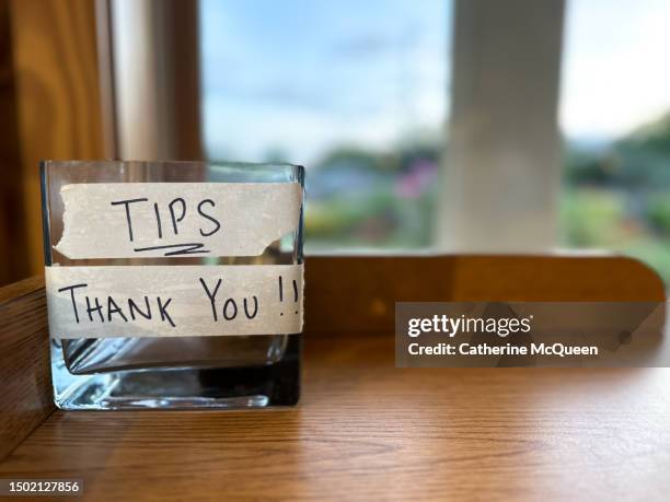 empty glass tip jar in restaurant - tip jar stock pictures, royalty-free photos & images