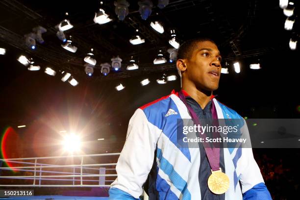 Gold medalist Anthony Joshua of Great Britain walks away from the ring after the medal ceremony for the Men's Super Heavy Boxing final bout on Day 16...