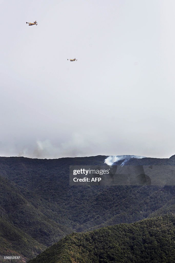 Smoke billows from a wildfire over the N