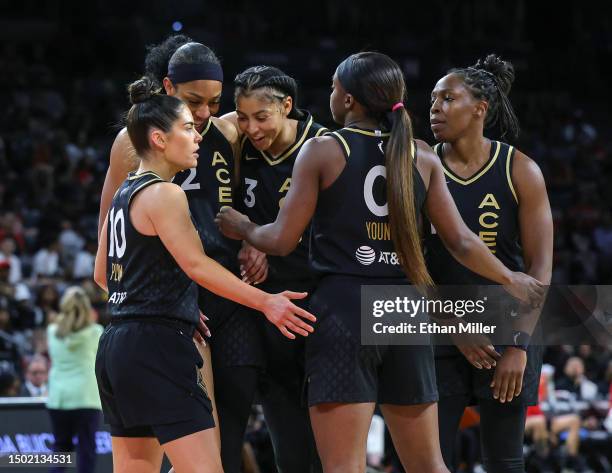Kelsey Plum, A'ja Wilson, Candace Parker, Jackie Young and Chelsea Gray of the Las Vegas Aces huddle on the court in the third quarter of a game...