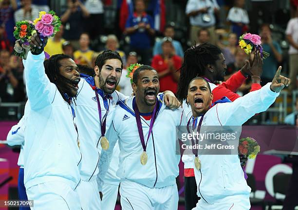 Cedric Sorhaindo, Nikola Karabatic, Didier Dinart and Daniel Narcisse of France celebrate after winning the gold medal against Sweden during the...