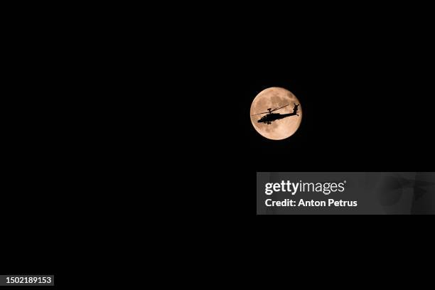 military helicopter on the background of the full moon - attack helicopter stock pictures, royalty-free photos & images