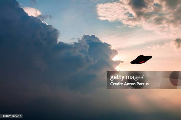 unidentified flying object in the sky. ufo invasion - ufo saucer stock pictures, royalty-free photos & images