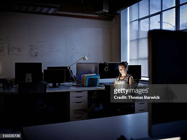 businesswoman working on digital tablet at night - alone office night stockfoto's en -beelden