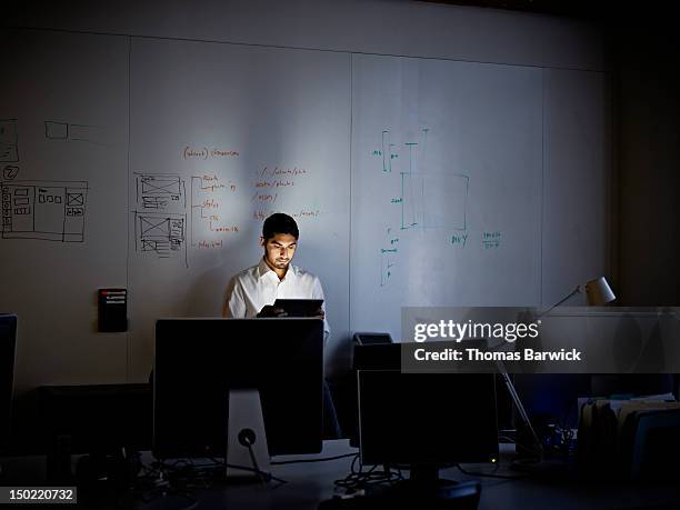 businessman working on digital tablet at night - working overtime fotografías e imágenes de stock