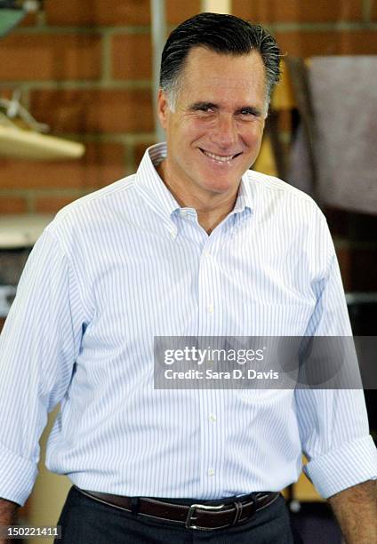 Republican presidential candidate, former Massachusetts Gov. Mitt Romney listens to cheers during a campaign stop at the Absolute Style furniture...