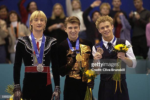 Evgeni Plushenko of Russia,silver, Alexei Yagudin of Russia, gold, Timothy Goebel of USA, bronze, receive their medals after competing in the men's...