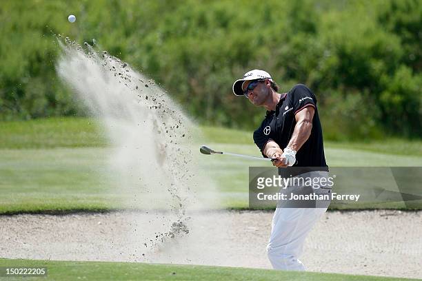 Adam Scott of Australia hits out of the sand on the fourth hole during the Final Round of the 94th PGA Championship at the Ocean Course on August 12,...