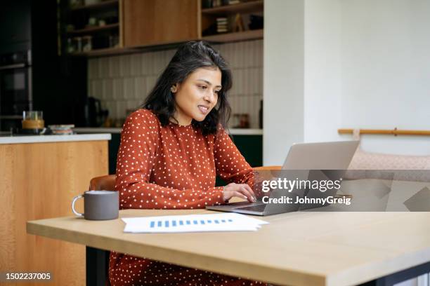 british indian businesswoman using laptop at home - interface dots stock pictures, royalty-free photos & images