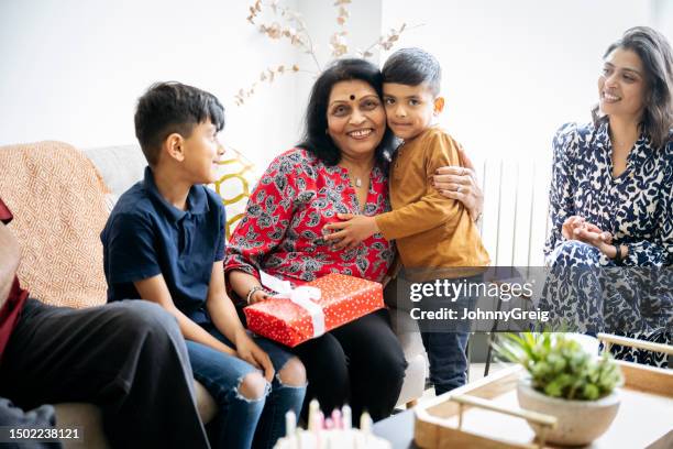 portrait of grandmother enjoying birthday celebration - annual event stock pictures, royalty-free photos & images