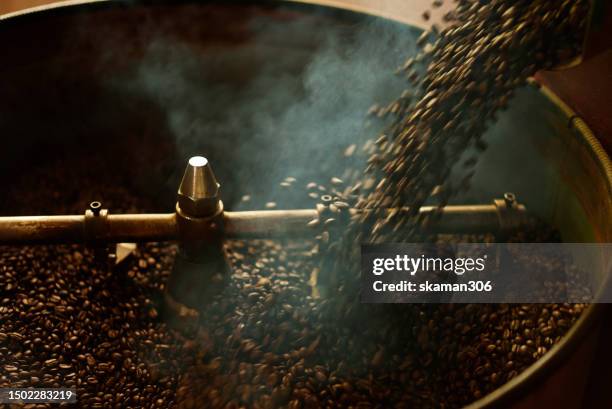 coffee beans dark roast pouring to cooling batch after finish process roasting coffee beans - grain-de-café-vert photos et images de collection