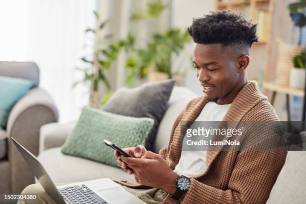 typing, black man and phone for online shopping, ecommerce and communication for payment, transaction or sale. customer, person and reading notification, alert or e ccommerce on technology in home - paid search stock pictures, royalty-free photos & images
