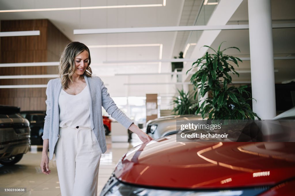 Confident mid age woman looking out for the new car