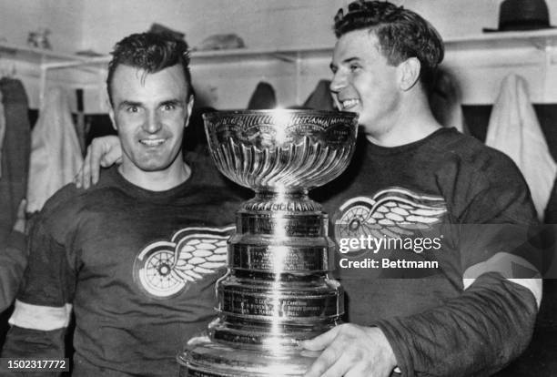 The Detroit Red Wings' Pete Babando and goalie Harry Lumley pose with the Stanley Cup in Detroit, April 25th 1950. The Red Wings won the Cup after...