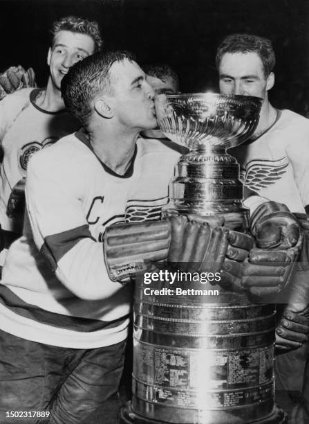 Detroit Red Wings captain Ted Lindsay kisses the Stanley Cup after the Red Wings defeated the Montreal Canadiens in Detroit, April 16th 1954. Also...