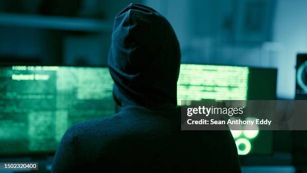 hacker, it and person with code on computer, programming and phishing scam with malware or virus. hacking, system glitch and cloud computing error in dark room, cyber crime and cybersecurity fail - computer hacker stockfoto's en -beelden