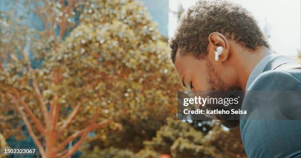 music, earphones and black man in city for business, streaming podcast and audio, sound or jazz. radio, listening and african professional person in urban town, serious and outdoor for hip hop track - boom for real stock pictures, royalty-free photos & images