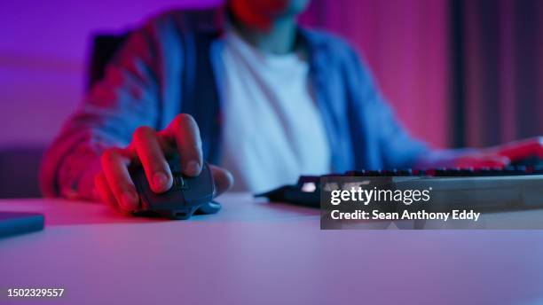 keyboard, mouse and hands of person gaming in dark neon bedroom, home or night closeup of pc gamer, streamer or computer click for playing video game, esports or streaming connection for cyber battle - close up computer mouse imagens e fotografias de stock