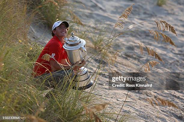 Rory McIlroy of Northern Ireland holds up the Wanamaker Trophy after winning the 94th PGA Championship at the Ocean Course on August 12, 2012 in...