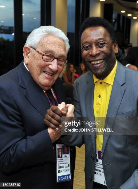 Henry Kissinger and former Brazilian footballer Pele pose for pictures during the closing ceremony of the 2012 London Olympic Games at the Olympic...