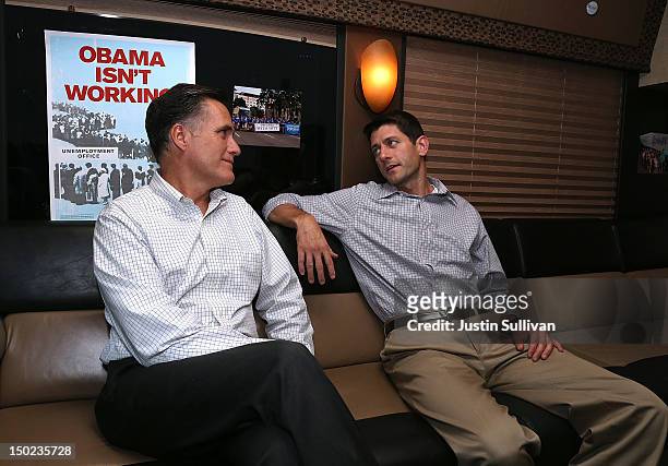 Republican presidential candidate and former Massachusetts Governor Mitt Romney and his running mate Rep. Paul Ryan talk on their campaign bus before...
