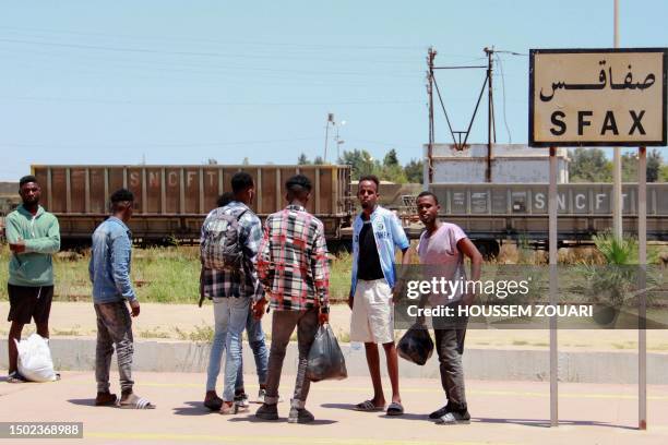 African migrants wait for a train at the train station on July 5 as they flee to Tunis amid unrest in Sfax following the stabbing on July 3 of a...