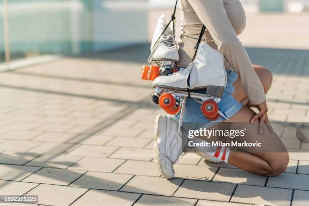 young spanish woman rollerblading on the promenade by the sea. - hot pants stock pictures, royalty-free photos & images