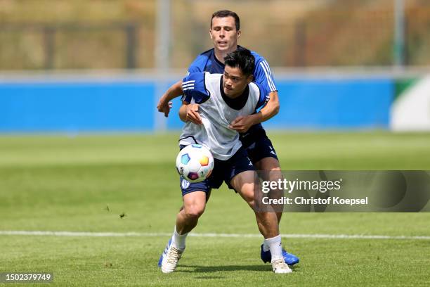 Ron Schallenberg challenges Soichiro Kozuki of Schalke during a training session at Parkstadion on June 26, 2023 in Gelsenkirchen, Germany. FC...