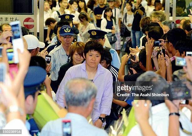 Miho Fukumoto and Aya Miyama are welcomed by supporters upon arrival at Osaka Airport on August 11, 2012 in Osaka, Japan.