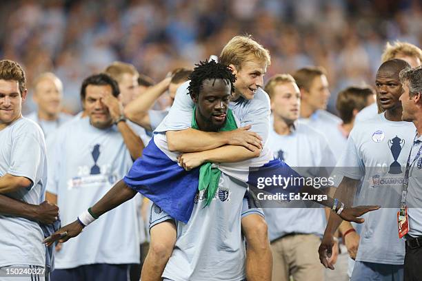 Kei Kamara of the Sporting Kansas City and Seth Sinovic of the Sporting Kansas City celebrates after defeating the Seattle Sounders FC to win the...