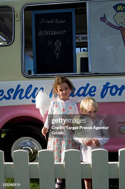 Two children pose with their candyfloss during the Engel & Voelkers Berlin Maifeld Cup near Olympic Stadium on August 12, 2012 in Berlin, Germany.