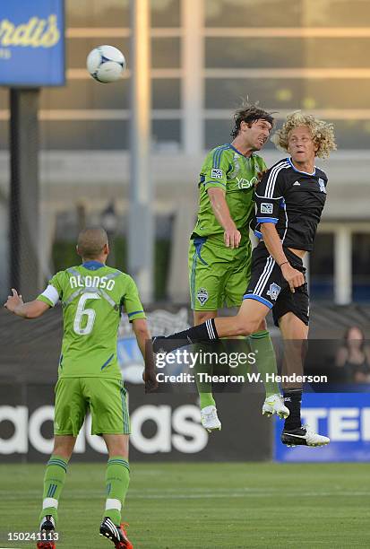 Steven Lenhart of the San Jose Earthquakes hits a header over Jeff Parke of the Seattle Sounders during an MLS Soccer game at Buck Shaw Stadium on...