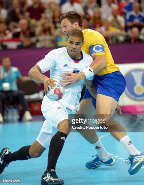 Daniel Narcisse of France with Tobias Karlsson of Sweden during the Men's Handball Gold Medal Match on Day 16 of the London 2012 Olympic Games at...
