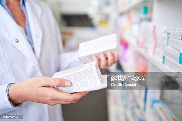 female pharmacist holding medicines, close up of hands - prescription drug stock pictures, royalty-free photos & images