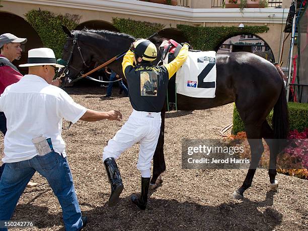 Jockey Juan Hernandez prepares to race Playboy TV personality Josie Goldberg's thoroughbred horse, "Only Josie Knows" at Del Mar Thoroughbred Club on...