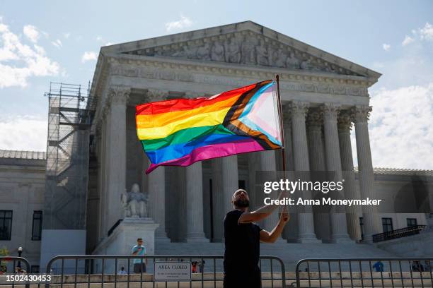 Same-sex marriage supporter Vin Testa, of Washington, DC, waves a LGBTQIA pride flag in front of the U.S. Supreme Court Building as he makes pictures...