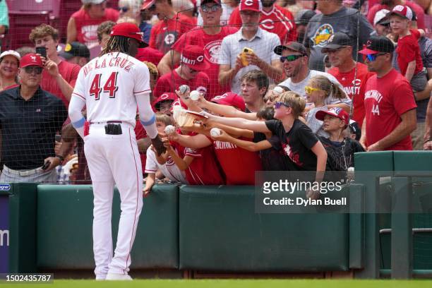 Elly De La Cruz of the Cincinnati Reds signs autographs for fans before the game against the Atlanta Braves at Great American Ball Park on June 25,...