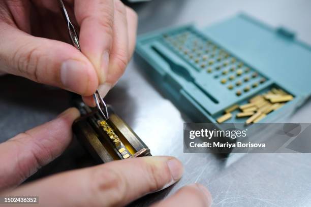 a vegan factory worker prints expiration dates on labels. - printing block stock pictures, royalty-free photos & images