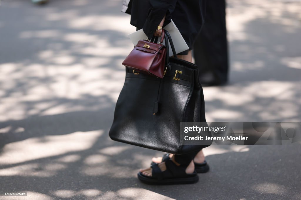 Fashion Week guest is seen wearing a black leather Hermes 50