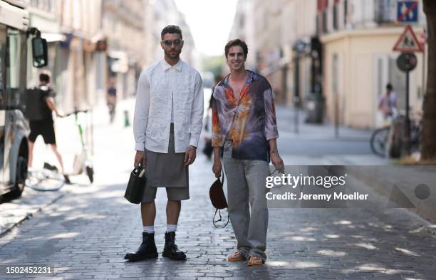 Matthias Geerst is seen wearing a colorful shirt combined with light demin jeans, a brown round bag and havaianas orange and yellow flip flops....