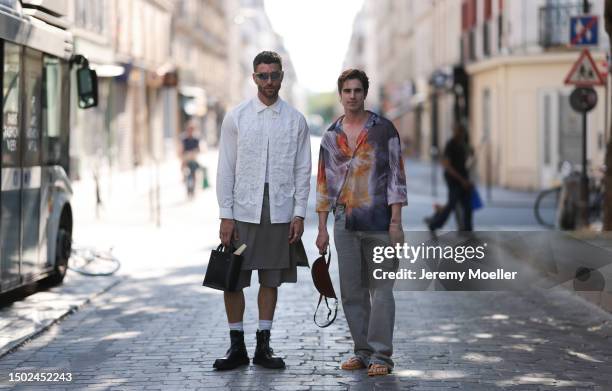 Matthias Geerst is seen wearing a colorful shirt combined with light demin jeans, a brown round bag and havaianas orange and yellow flip flops....