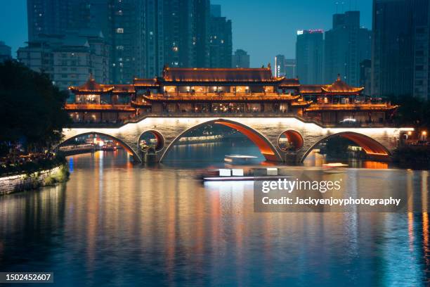chengdu's illuminated anshun bridge with reflection - guizhou province stock pictures, royalty-free photos & images