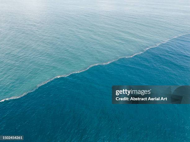 aerial image showing a reef in the indian ocean at high tide, uluwatu, bali, indonesia - bandung conference - fotografias e filmes do acervo