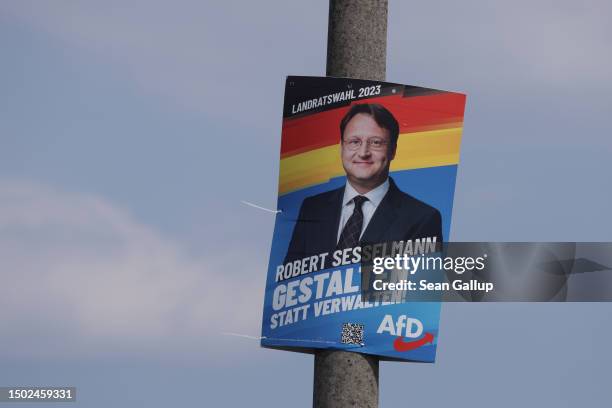 An election campaign poster for Robert Sesselmann, candidate of the right-wing Alternative for Germany in the local district office election, hangs...