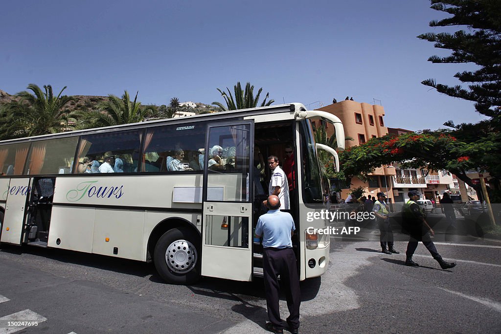 People boar a bus during an evacuation i