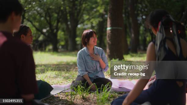 multi-ethnic group people meeting in nature for group therapy session - healthcare worker beauty in nature stock pictures, royalty-free photos & images