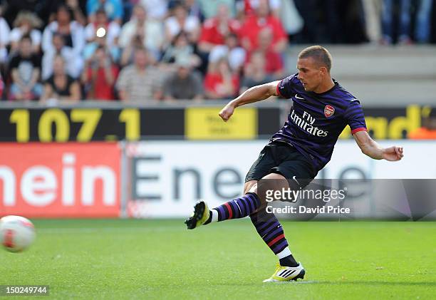 Lukas Podolski scores Arsenal's 2nd goal from the penalty spot against FC Cologne during Pre-Season Friendly game at Rhein Energie Stadium on August...