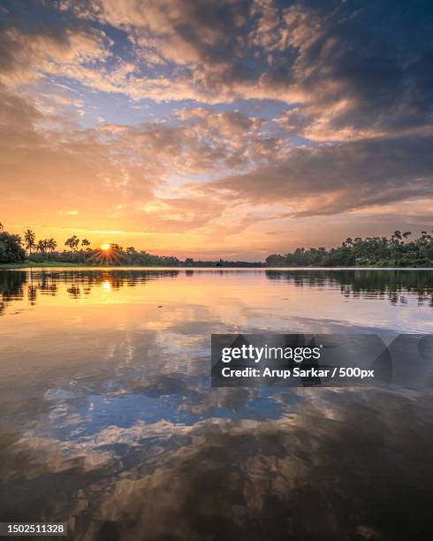 scenic view of lake against sky during sunset,malda division,west bengal,india - reflection water india stock pictures, royalty-free photos & images