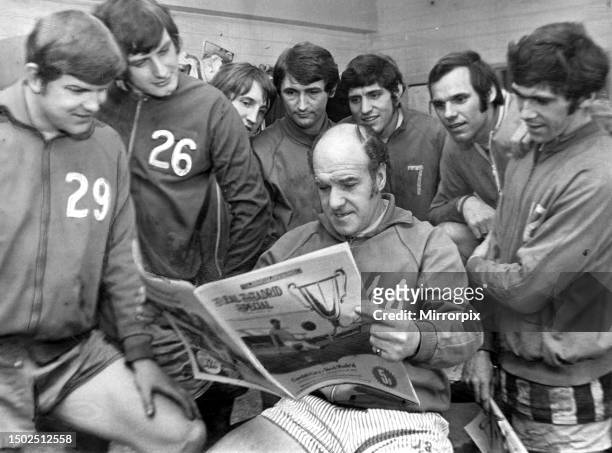 Cardiff City manager Jimmy Scoular, pictured with members of the his team in the dressing room, at Ninian Park, looking at the South Wales Echo ahead...